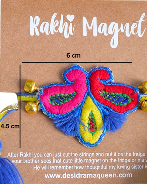 Close-up of Titli-Kairi embroidered rakhi magnet on display card, showcasing handcrafted butterfly and paisley design with reusable fridge magnet.
