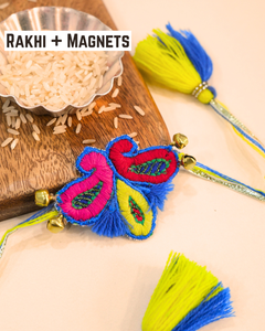 Paisely embroidered rakhi magnet placed beside a bowl of rice, beautifully styled for a festive Raksha Bandhan celebration.