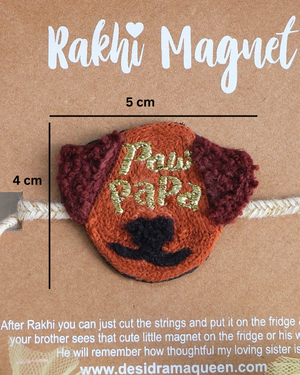 Close-up of Paw Papa embroidered rakhi magnet on display card, showcasing handcrafted design and reusable keepsake fridge magnet.