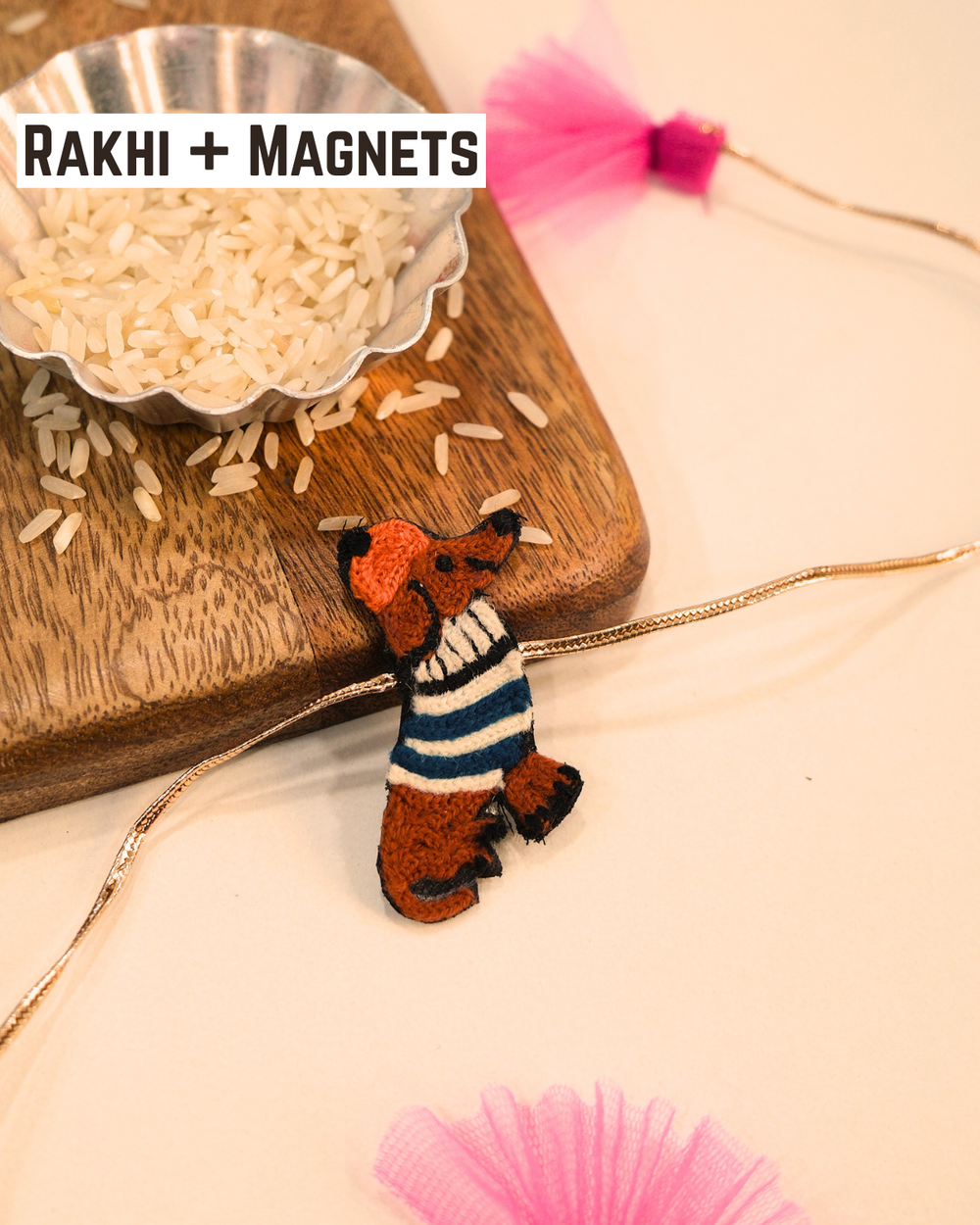Weiner Dog embroidered rakhi magnet placed beside a bowl of rice, styled for a festive Raksha Bandhan celebration.
