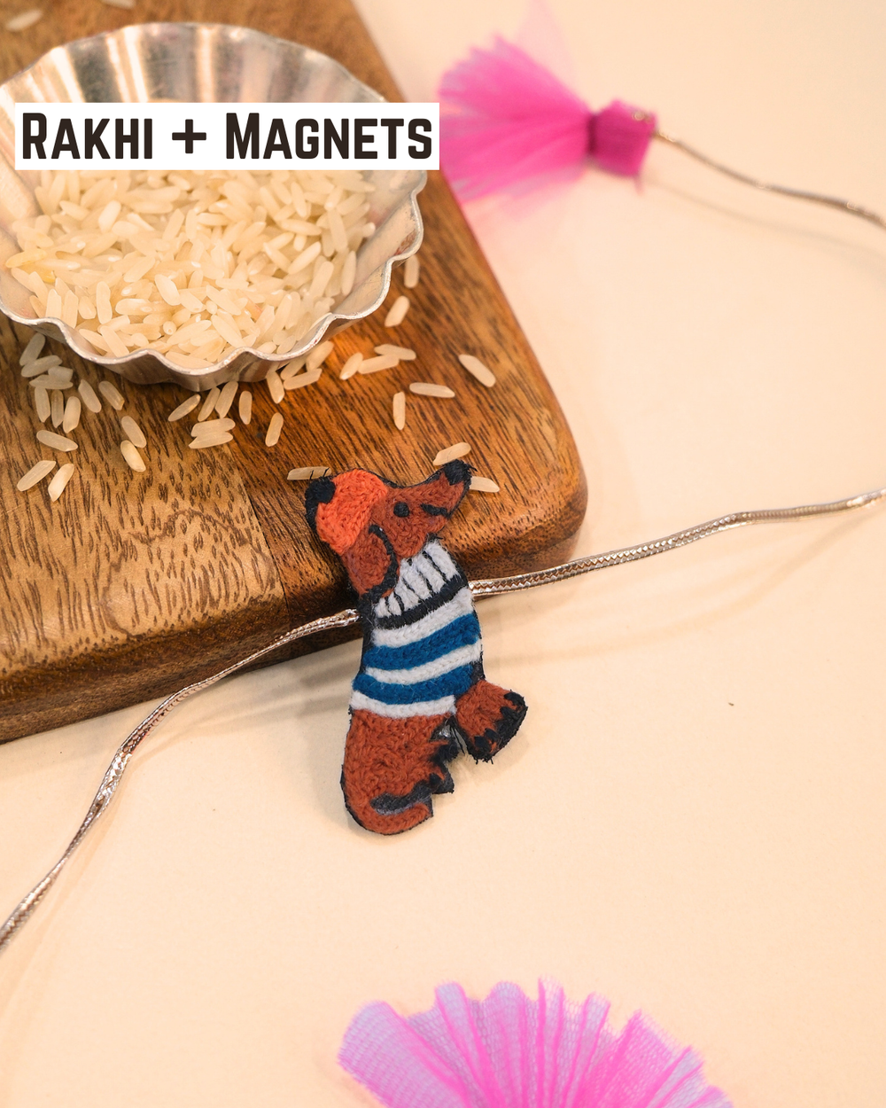 Weiner Dog embroidered rakhi magnet placed beside a bowl of rice, styled for a festive Raksha Bandhan celebration.