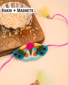 Butterfly embroidered rakhi magnet placed beside a bowl of rice, beautifully styled for a festive Raksha Bandhan celebration.