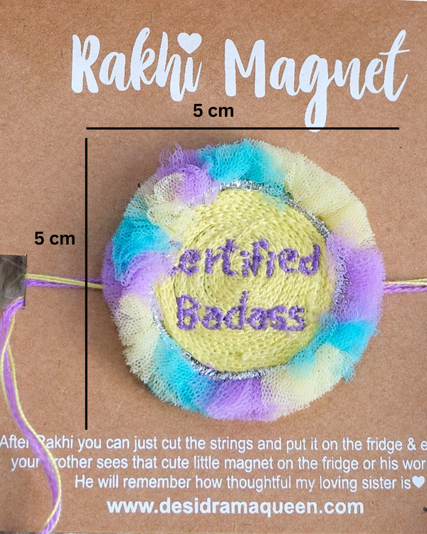 Close-up of Certified Badass embroidered rakhi magnet on display card, showcasing handcrafted design and reusable keepsake fridge magnet.