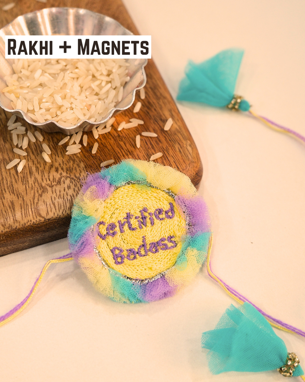 Certified Badass embroidered rakhi magnet placed beside a bowl of rice, styled for a festive Raksha Bandhan celebration.