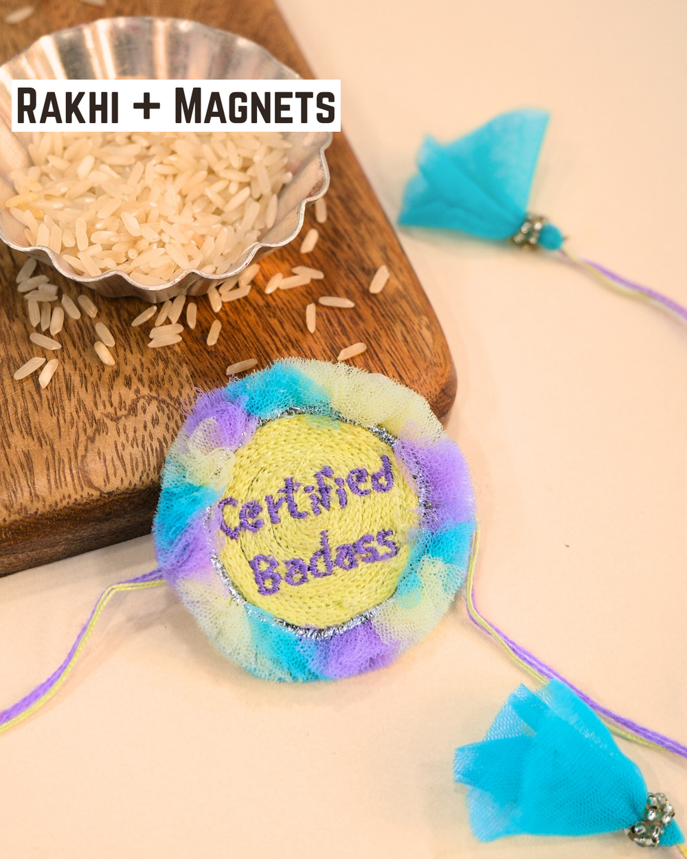 Certified Badass embroidered rakhi magnet placed beside a bowl of rice, styled for a festive Raksha Bandhan celebration.