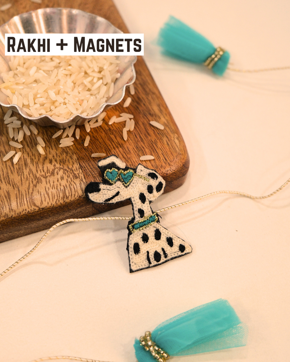 Cool Dog embroidered rakhi magnet placed beside a bowl of rice, styled for a festive Raksha Bandhan celebration.