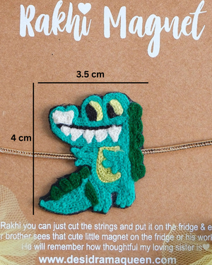 Close-up of Crocodile embroidered rakhi magnet on display card, showcasing handcrafted design and reusable keepsake fridge magnet.