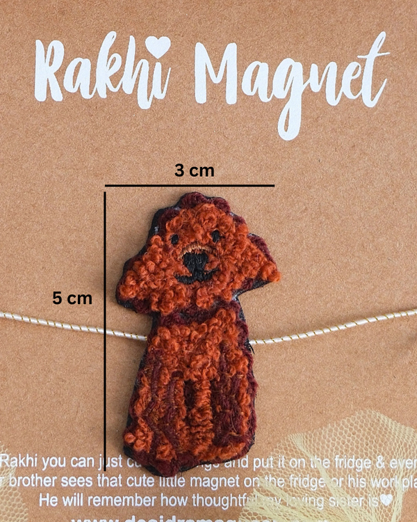 Close-up of Cute Dog embroidered rakhi magnet on display card, showcasing handcrafted design and reusable keepsake fridge magnet.