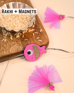 Cute Rakhi Magnet Fish displayed with soft pink threads and tassels, adding a playful ocean-inspired touch to Raksha Bandhan.
