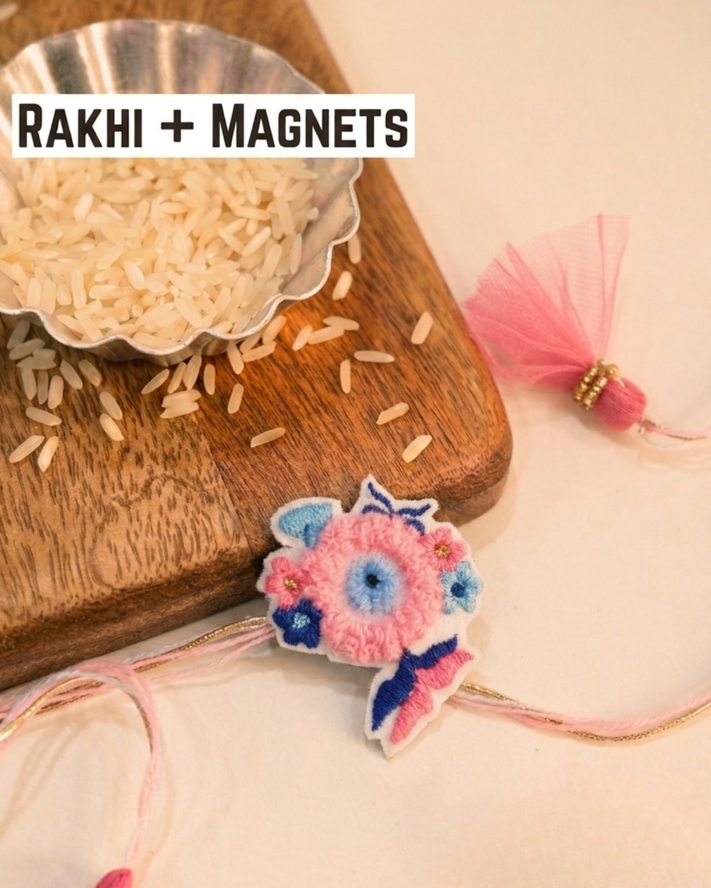 Handcrafted Evil Eye Floral Rakhi magnet displayed with soft pink threads and tassels, blending protection with beautiful floral charm.