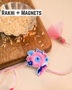 Handmade floral embroidery Rakhi online, unique 2-in-1 reusable Rakhi magnet, modern designer pink and blue sister-brother thread, eco-friendly Raksha Bandhan keepsakes.