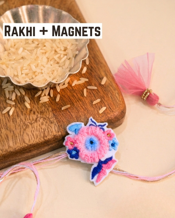 Handmade floral embroidery Rakhi online, unique 2-in-1 reusable Rakhi magnet, modern designer pink and blue sister-brother thread, eco-friendly Raksha Bandhan keepsakes.