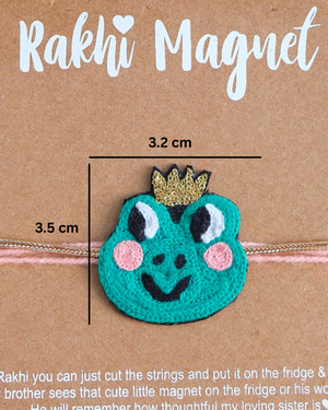 Packaged Frog Prince Rakhi magnet on a wooden backdrop, showcasing a charming handcrafted gift for playful Raksha Bandhan celebrations.