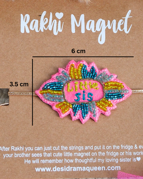 Close-up of Little Sis embroidered rakhi magnet on display card, showcasing handcrafted design and reusable keepsake fridge magnet.