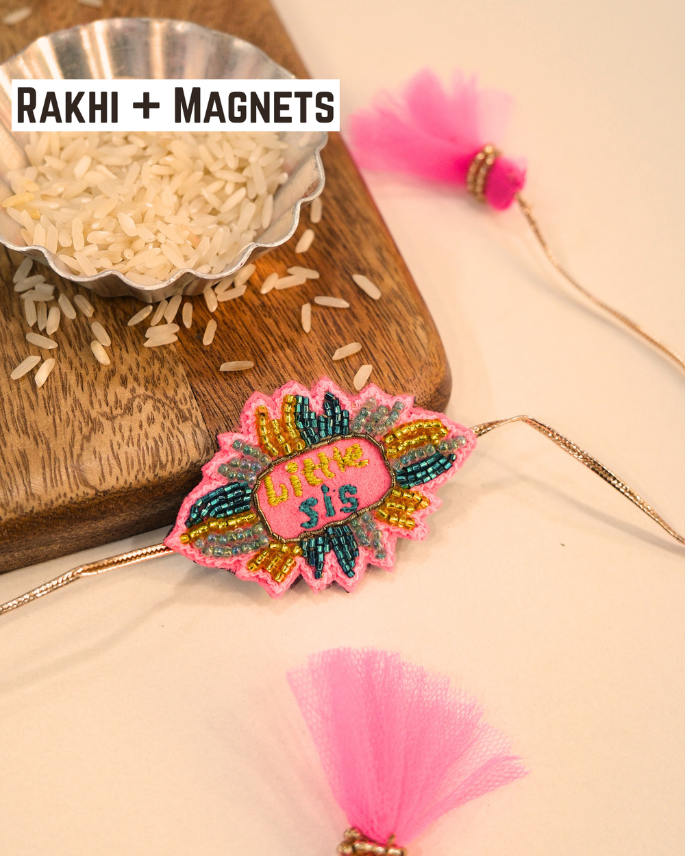 Little Sis embroidered rakhi magnet placed beside a bowl of rice, styled for a festive Raksha Bandhan celebration.