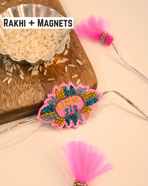 Little Sis embroidered rakhi magnet placed beside a bowl of rice, styled for a festive Raksha Bandhan celebration.
