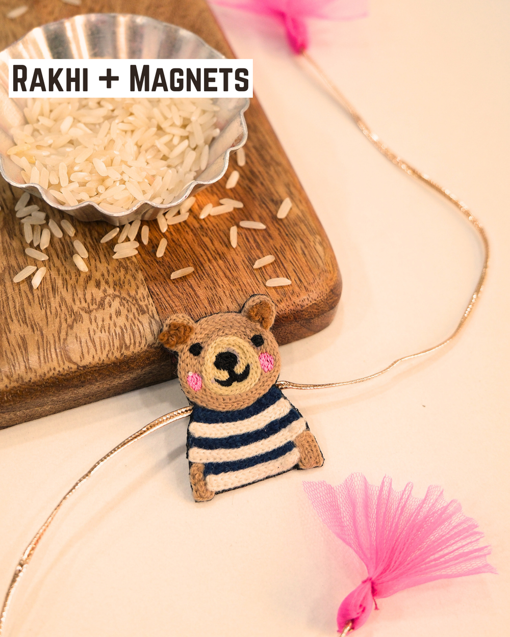 Panda embroidered rakhi magnet placed beside a bowl of rice, styled for a festive Raksha Bandhan celebration.