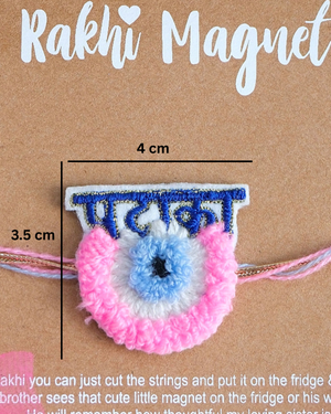 Close-up of Pataka Evil Eye embroidered rakhi magnet on display card, showcasing handcrafted design and reusable keepsake fridge magnet.