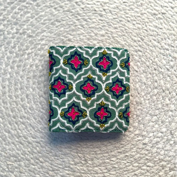 Square fabric patch with a geometric pattern on a textured white background
