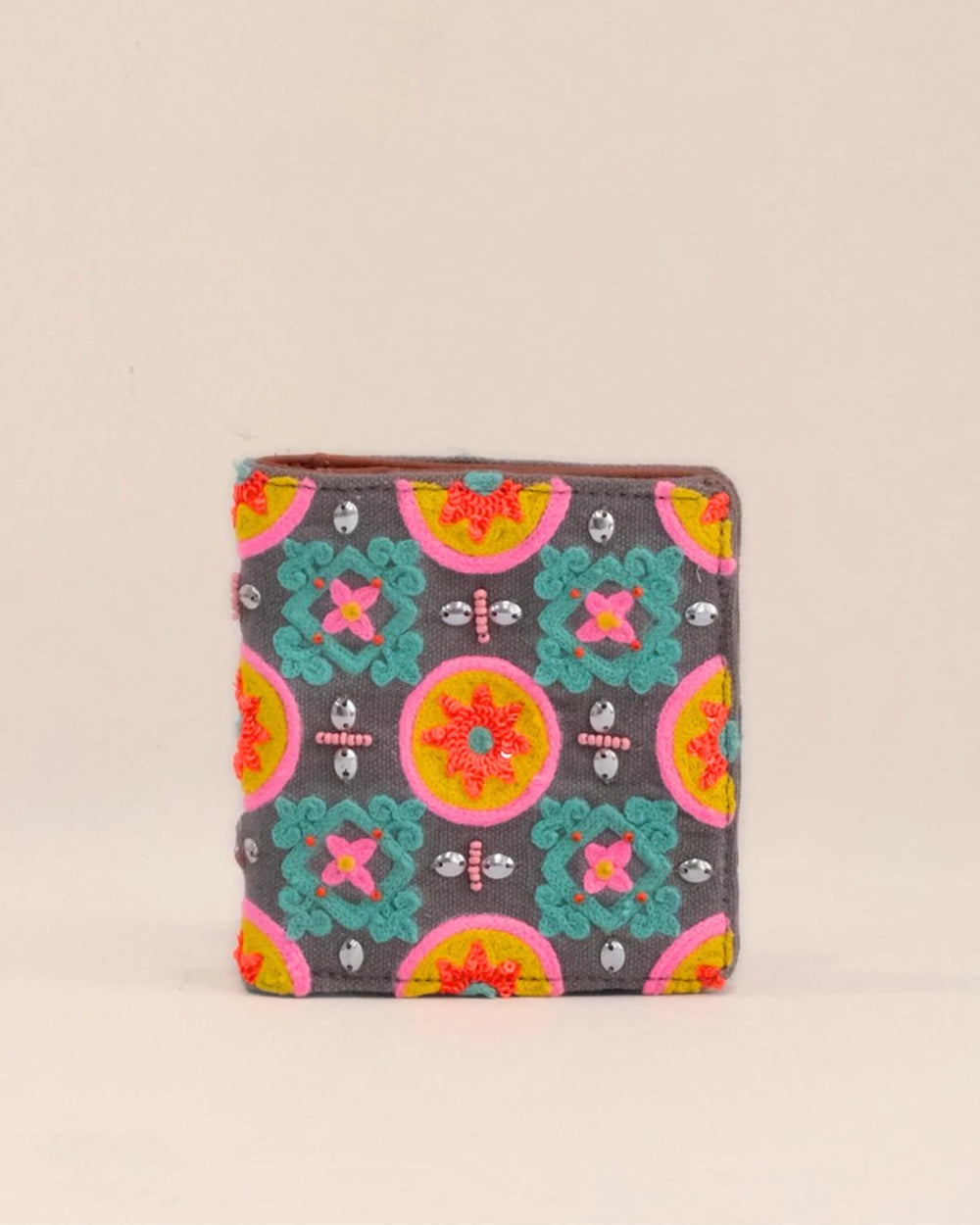 Colorful patterned wallet on a beige background
