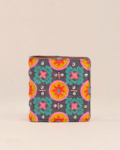 Colorful patterned wallet on a beige background