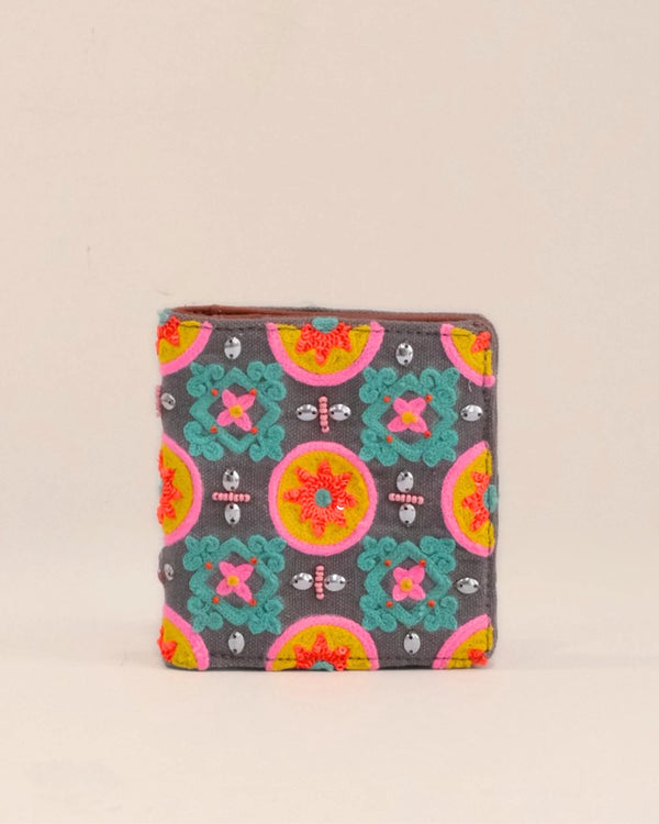 Colorful patterned wallet on a beige background