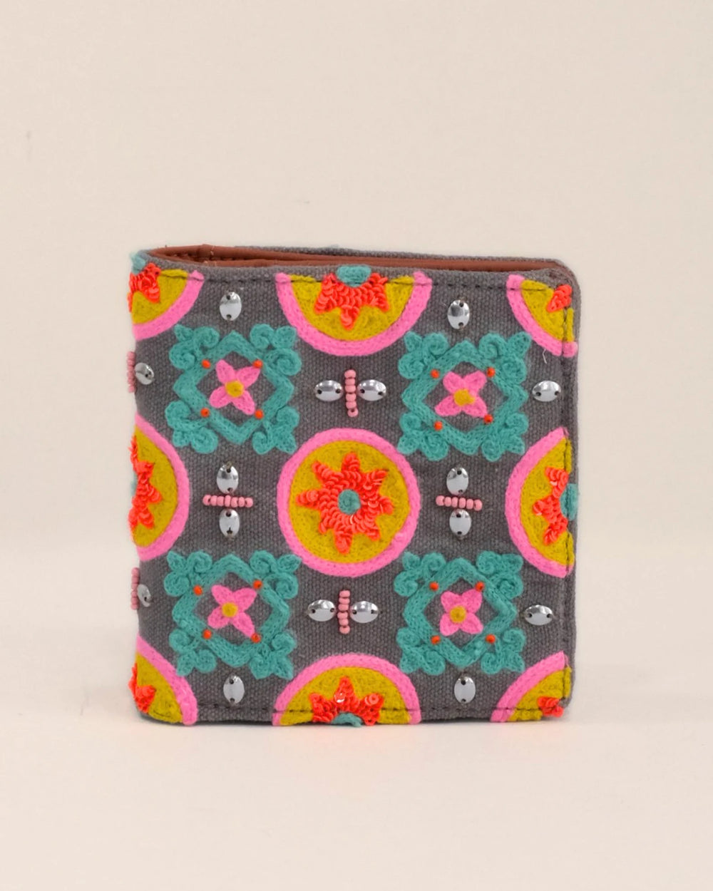 Colorful patterned wallet on a beige background