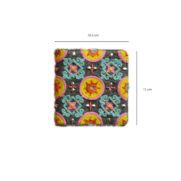 Colorful patterned fabric square with measurements on a white background