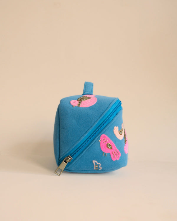 Durable fabric makeup pouch with pink and gold embroidered bird motifs, lightweight and chic design.