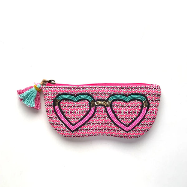 Small pouch with heart design and tassel on a white background