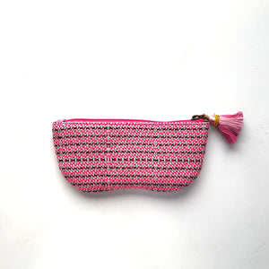 Woven pouch with pink zipper and tassel on a white background
