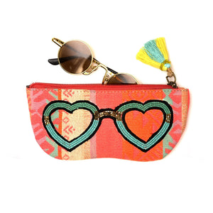 Sunglasses in a colorful pouch with heart design on a white background