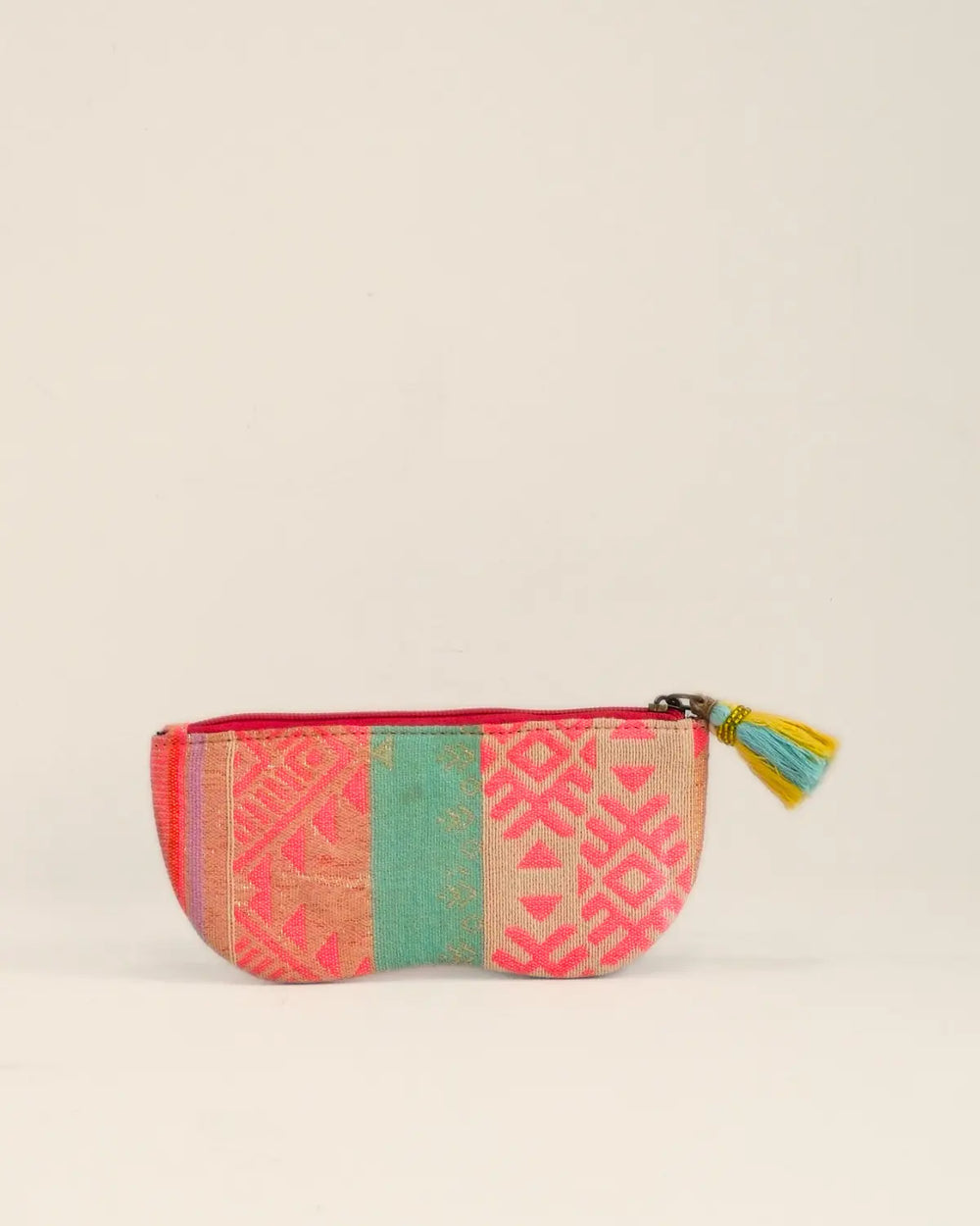 Small pouch with heart design and colorful pattern on a beige background