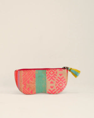 Colorful fabric pouch with geometric pattern on a beige background