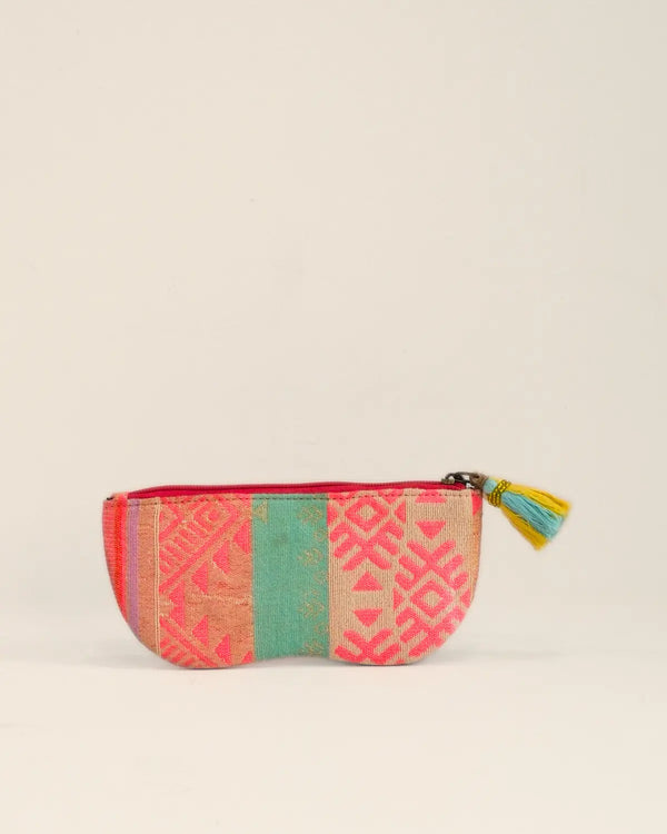 Colorful fabric pouch with geometric pattern on a beige background