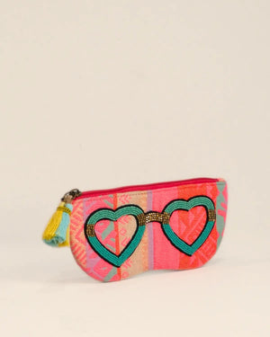 Small pouch with heart design and colorful pattern on a beige background
