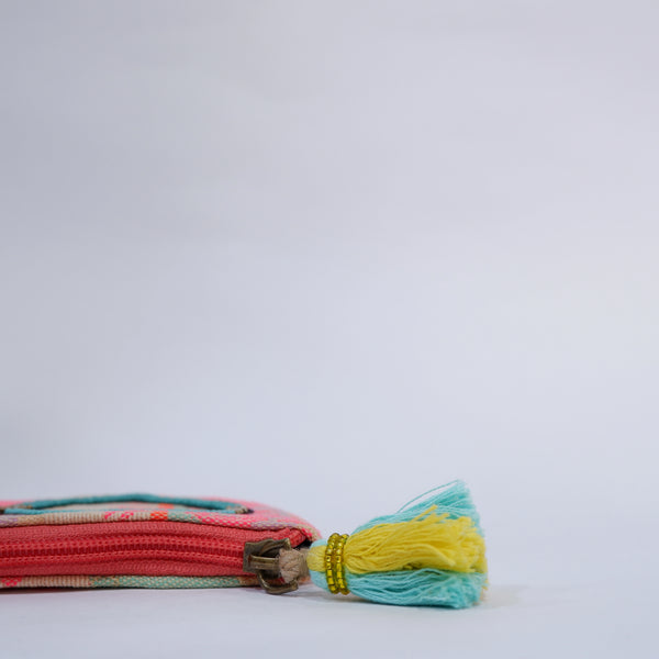 Colorful woven belt with a tassel on a white background