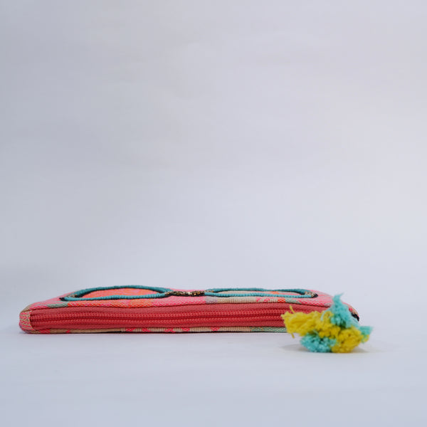 Colorful pouch with a tassel on a light gray background