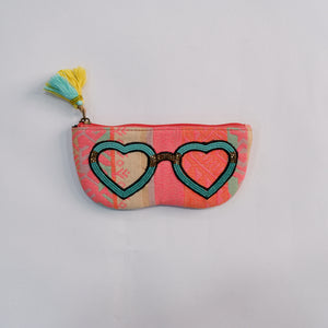 Small pouch with heart-shaped sunglasses design on a light gray background