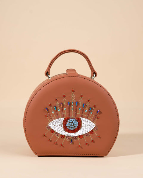 Tan box sling bag featuring evil eye embroidery with white katdana and golden zari work