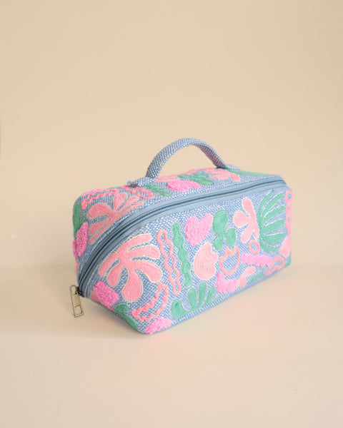 Lightweight embroidered makeup kit in pastel shades, ideal for organizing cosmetics and skincare.