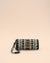 Handmade sunglass cover with tribal-inspired embroidery in black, white, gold, and blue, featuring secure strap handle.
