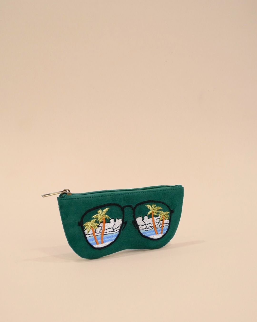 Green sunglass pouch with tropical embroidery featuring palm trees, clouds, and ocean, stylish handmade eyewear cover.