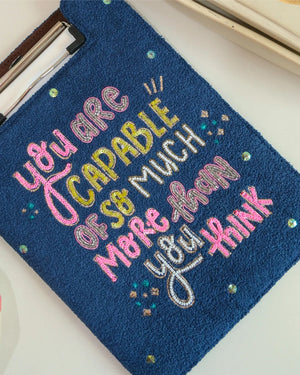 Embroidered patch with motivational quote on a blue background