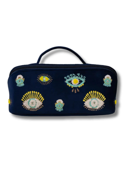 Navy blue cosmetic bag with eye designs on a blue background