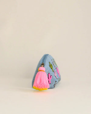 Small pouch with pink tassel on a beige background
