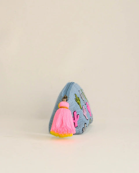 Small pouch with pink tassel on a beige background