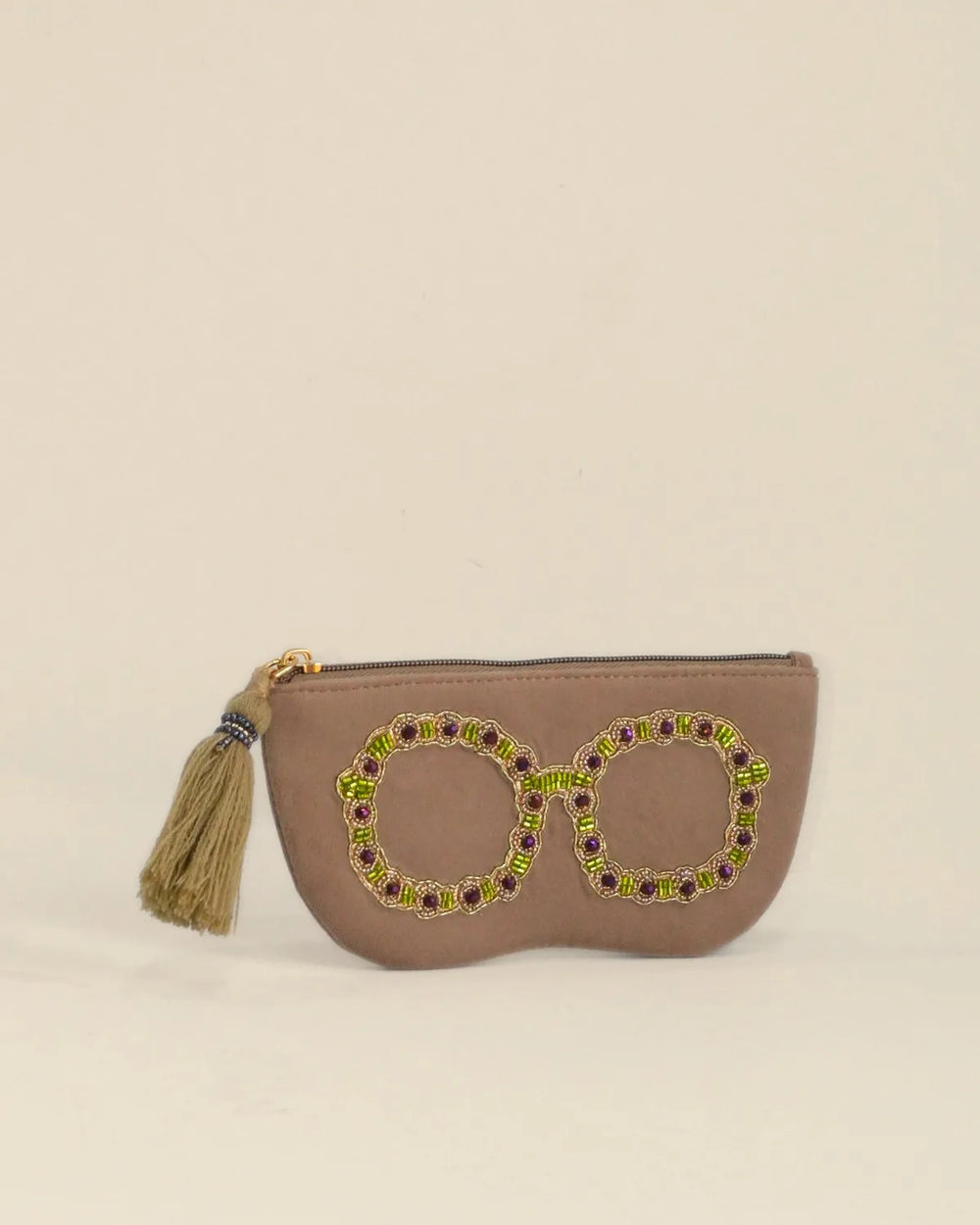 Brown pouch with decorative elements on a beige background