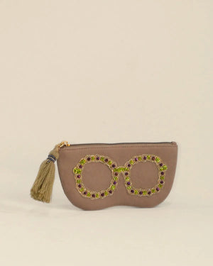 Beige pouch with decorative elements on a beige background