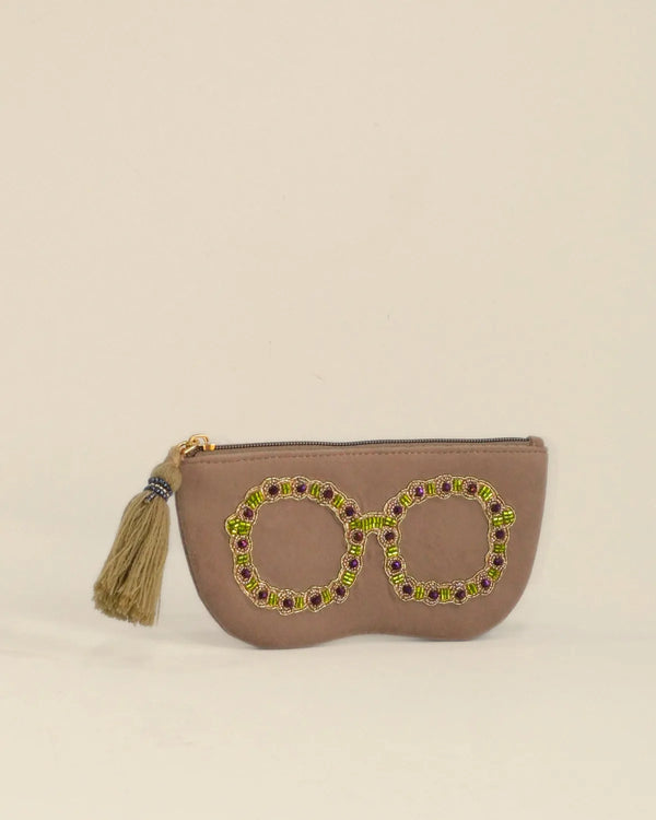 Beige pouch with decorative elements on a beige background